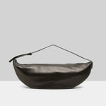 Back view of black marsell volta shoulder bag on white background, with no model shown.
