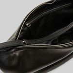 Open view of black marsell volta shoulder bag on white background, with no model shown.