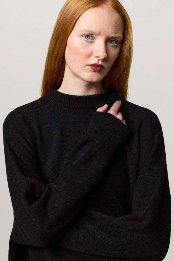 Front closeup view of nero amelia rn sweater on model, against a white background.