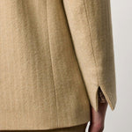 Back closeup view of naturale beatrix db jacket on model wearing naturale skirt, against a white background.
