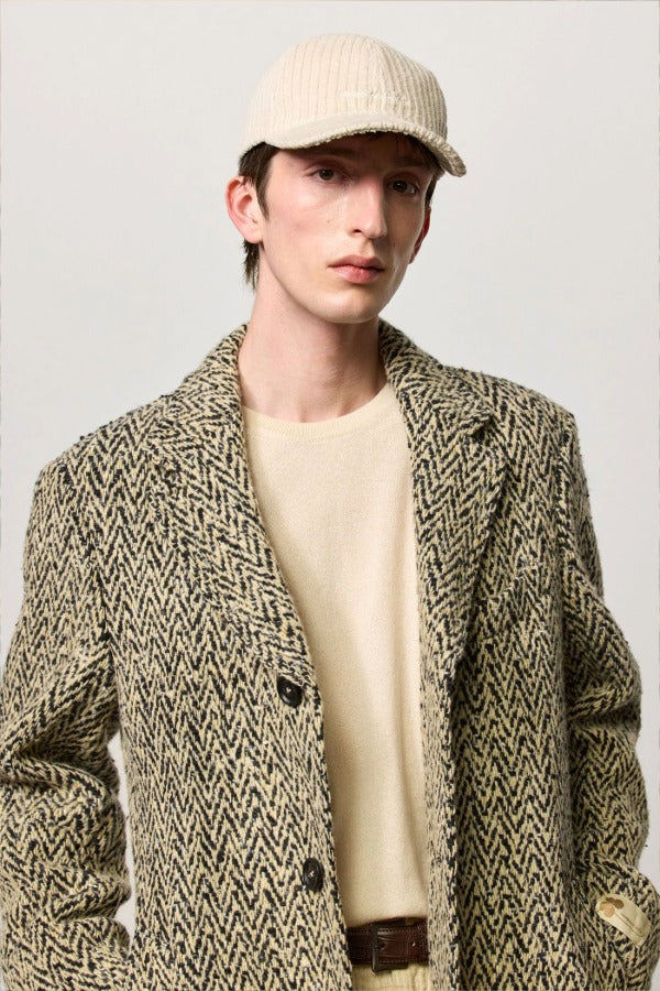 Front view of pearl chance hat on model wearing herringbone jacket and milk top, against a white background.