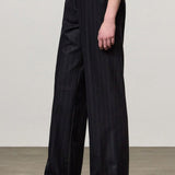 Side view of blu lamna trouser on model wearing brown top and boots, against a white backgorund.