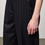 Front closeup view of blu lamna trouser on model wearing brown top, against a white background.