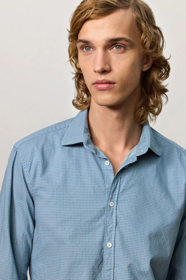 Front closeup view of blue rain canary shirt on model against a white background.