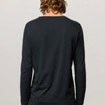 Back view of dark blue boa LS T-Shirt on model wearing tweed trousers, against a white background.