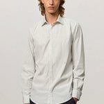 Front view of pine genova classic shirt on model wearing black trousers, against a white background.