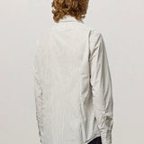 Back view of pine genova classic shirt on model wearing black trousers, against a white background.