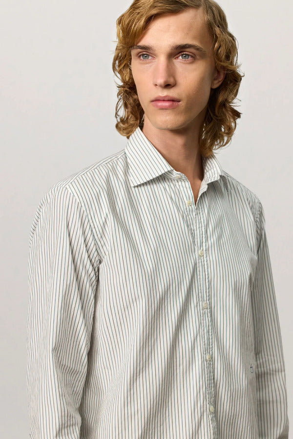 Front closeup view of pine genova classic shirt on model wearing black trousers against a white background.