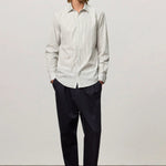 Front view of pine genova classic shirt on model wearing black trousers and brown suede shoes, against a white background.
