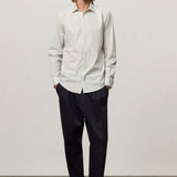 Front view of pine genova classic shirt on model wearing black trousers and brown suede shoes, against a white background.