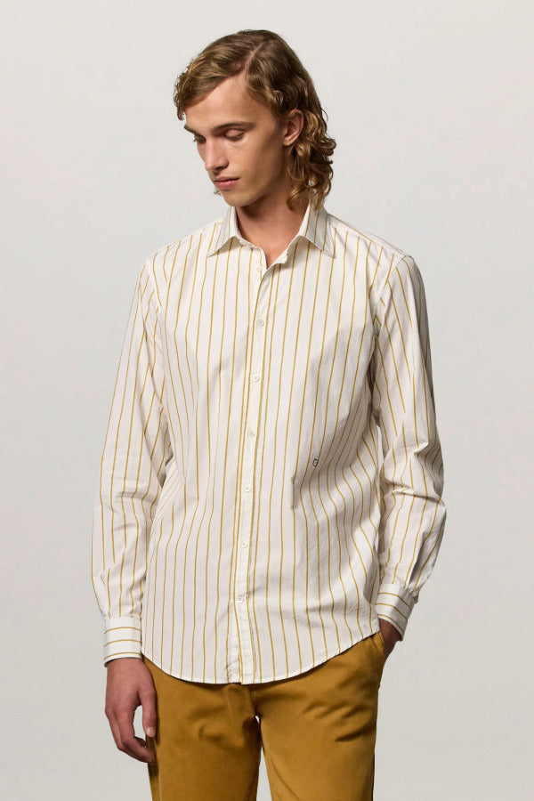 Front view of saffron genova classic shirt on model wearing saffron trousers, against a white background.