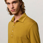 Front closeup view of saffron ischia ls polo shirt on model, against a white background.