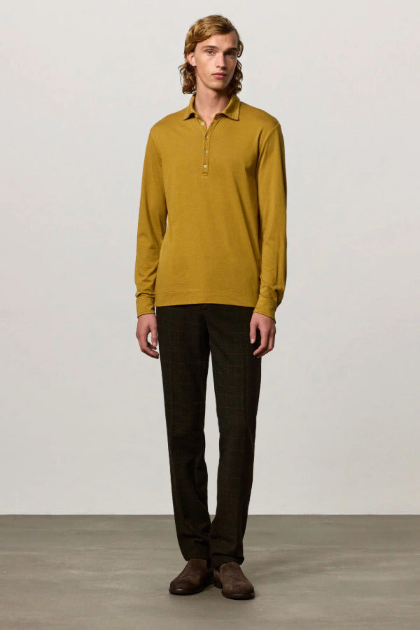 Front view of saffron ischia ls polo shirt on model wearing brown tweed trousers and brown suede shoes, against a white background.