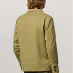 Back view of verde baglietto blazer on model wearing green corduroys, against a white background.