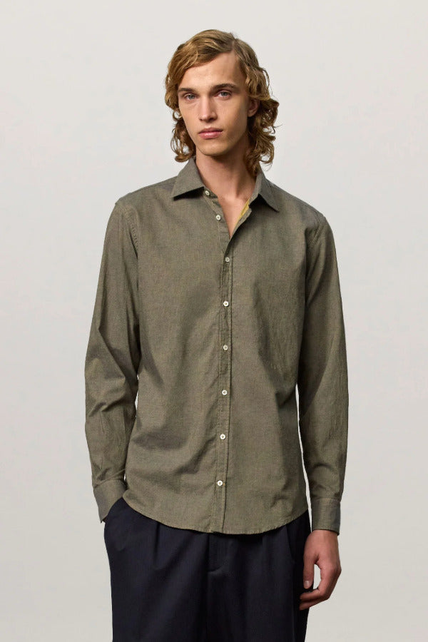 Front view of verde genova classic shirt on model wearing black trousers, against a white background.