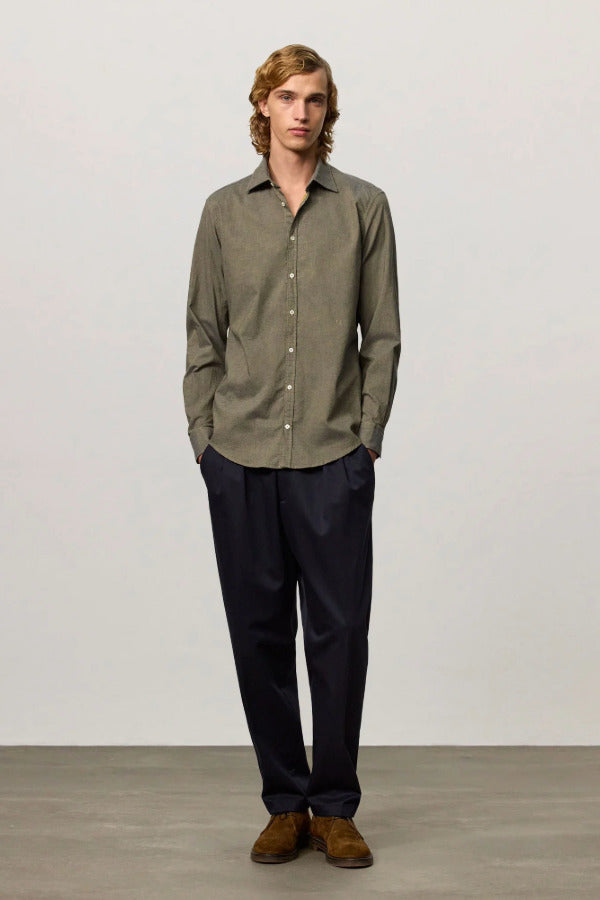 Front view of verde genova classic shirt on model wearing black trousers and brown suede shoes, against a white background.