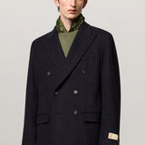 Front view of blue brando db blazer on model wearing green t-shirt and yellow pants, against a white background.