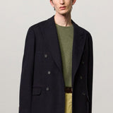 Alternate front view of blue brando db blazer on model wearing green t-shirt and yellow pants, against a white background.