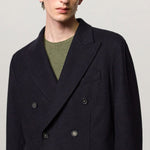 Front closeup view of blue brando db blazer on model wearing a green t-shirt, against a white background.