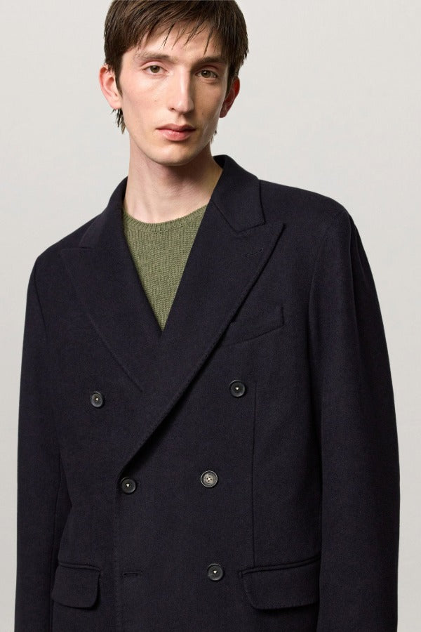 Front closeup view of blue brando db blazer on model wearing a green t-shirt, against a white background.
