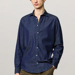 Front view of blu canary classic shirt on model wearing green pants, against a white background.