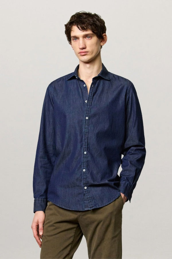 Front view of blu canary classic shirt on model wearing green pants, against a white background.