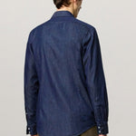 Back view of blu canary classic shirt on model wearing green pants, against a white background.