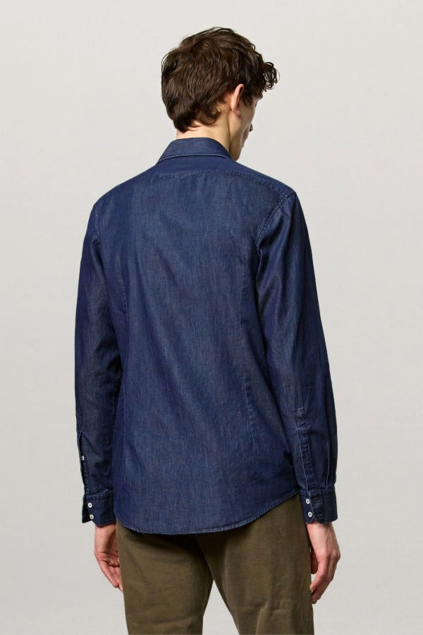 Back view of blu canary classic shirt on model wearing green pants, against a white background.