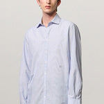 Front view of azzurro canary classic shirt on model wearing green pants, against a white background.