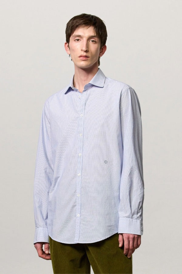 Front view of azzurro canary classic shirt on model wearing green pants, against a white background.