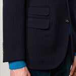 Front closeup view of blue catch2 jacket on model wearing blue sweater and pants, against a white background.