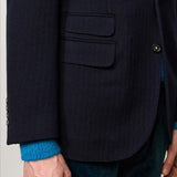 Front closeup view of blue catch2 jacket on model wearing blue sweater and pants, against a white background.