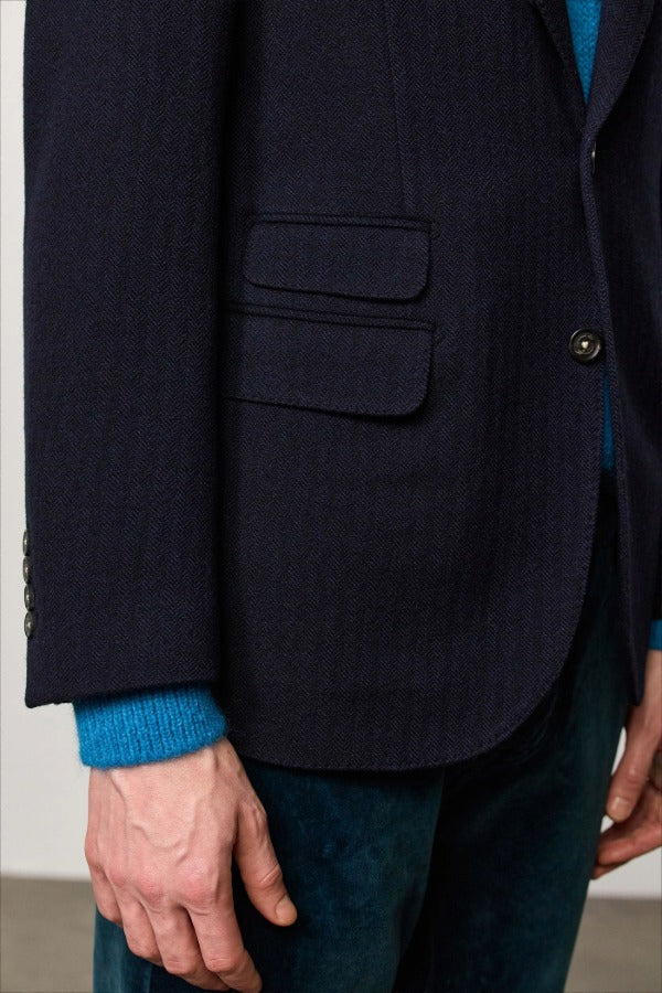 Front closeup view of blue catch2 jacket on model wearing blue sweater and pants, against a white background.