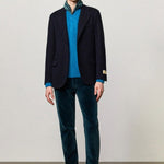 Front view of blue catch2 jacket on model wearing blue sweater and pants with boots, against a white background.