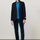 Front view of blue catch2 jacket on model wearing blue sweater and pants with boots, against a white background.