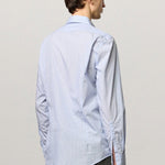 Back view of azzurro genova classic shirt on model wearing grey shirt, against a white background.