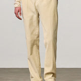 Front view of milk ionio2 trouser on model wearing milk top and brown boots, against a white background.
