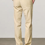 Back view of milk ionio2 trouser on model wearing milk top and brown boots, against a white background.