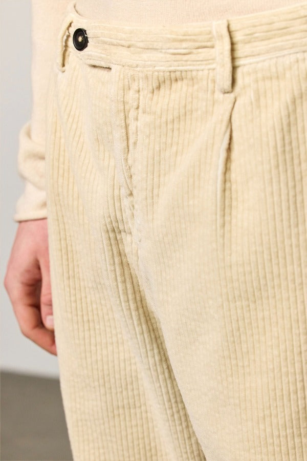 Front closeup view of milk ionio2 trouser on model wearing milk top, against a white background.