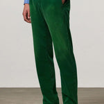 Front view of green ionio2 trouser on model wearing blue shirt and boots, against a white background.