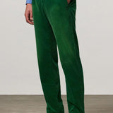 Front view of green ionio2 trouser on model wearing blue shirt and boots, against a white background.