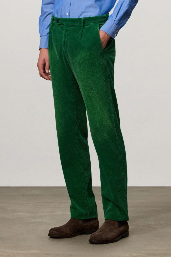 Front view of green ionio2 trouser on model wearing blue shirt and boots, against a white background.