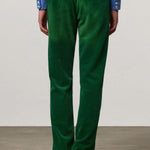 Back view of green ionio2 trouser on model wearing blue shirt and boots, against a white background.