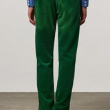 Back view of green ionio2 trouser on model wearing blue shirt and boots, against a white background.