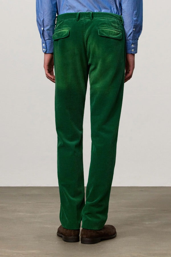 Back view of green ionio2 trouser on model wearing blue shirt and boots, against a white background.