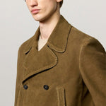 Side closeup view of rusk lucio peacoat on model, against a white background.