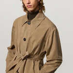 Front closeup view of beige mustang trench on model, against a white background.