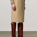 Front view of naturale rugaida skirt on model wearing ls shirt and boots, against a white background.