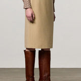 Front view of naturale rugaida skirt on model wearing ls shirt and boots, against a white background.