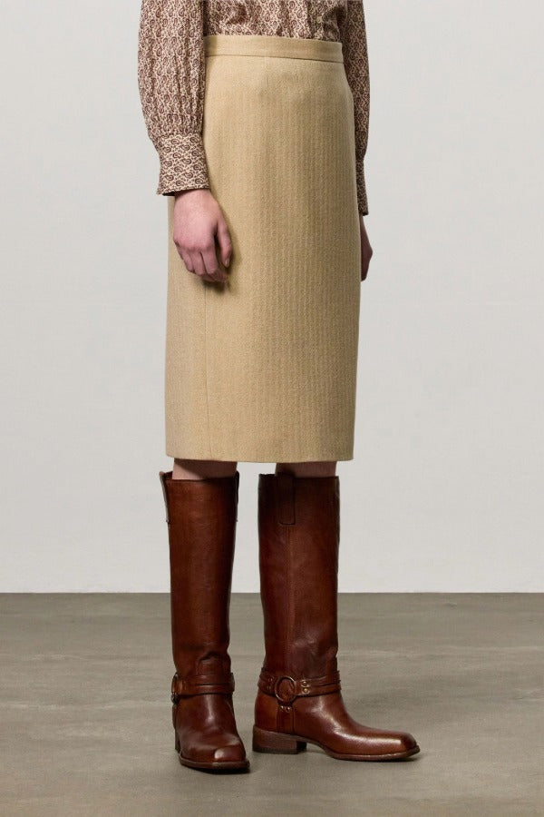 Front view of naturale rugaida skirt on model wearing ls shirt and boots, against a white background.